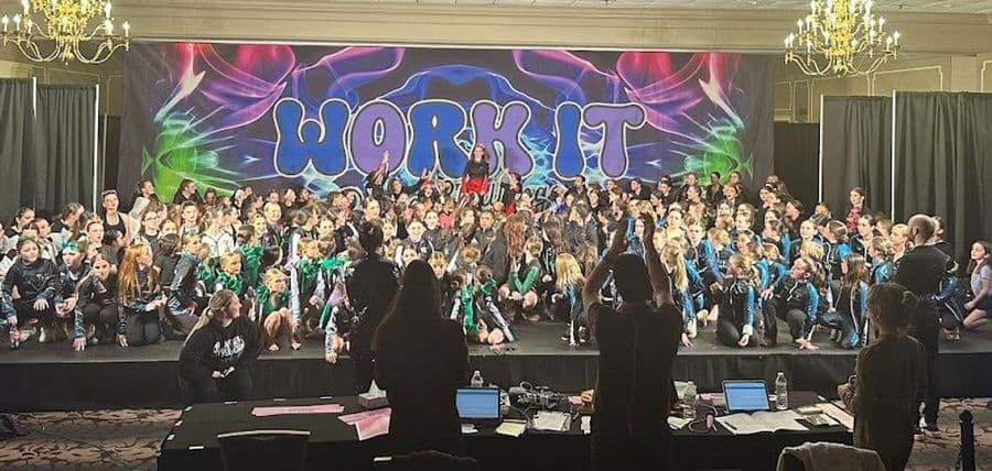 Hundreds of dancers on stage for the awards ceremony under the Work It backdrop